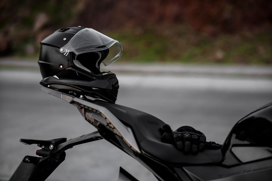 A stylish black motorcycle helmet rests on a sleek motorbike, ready for the ride.